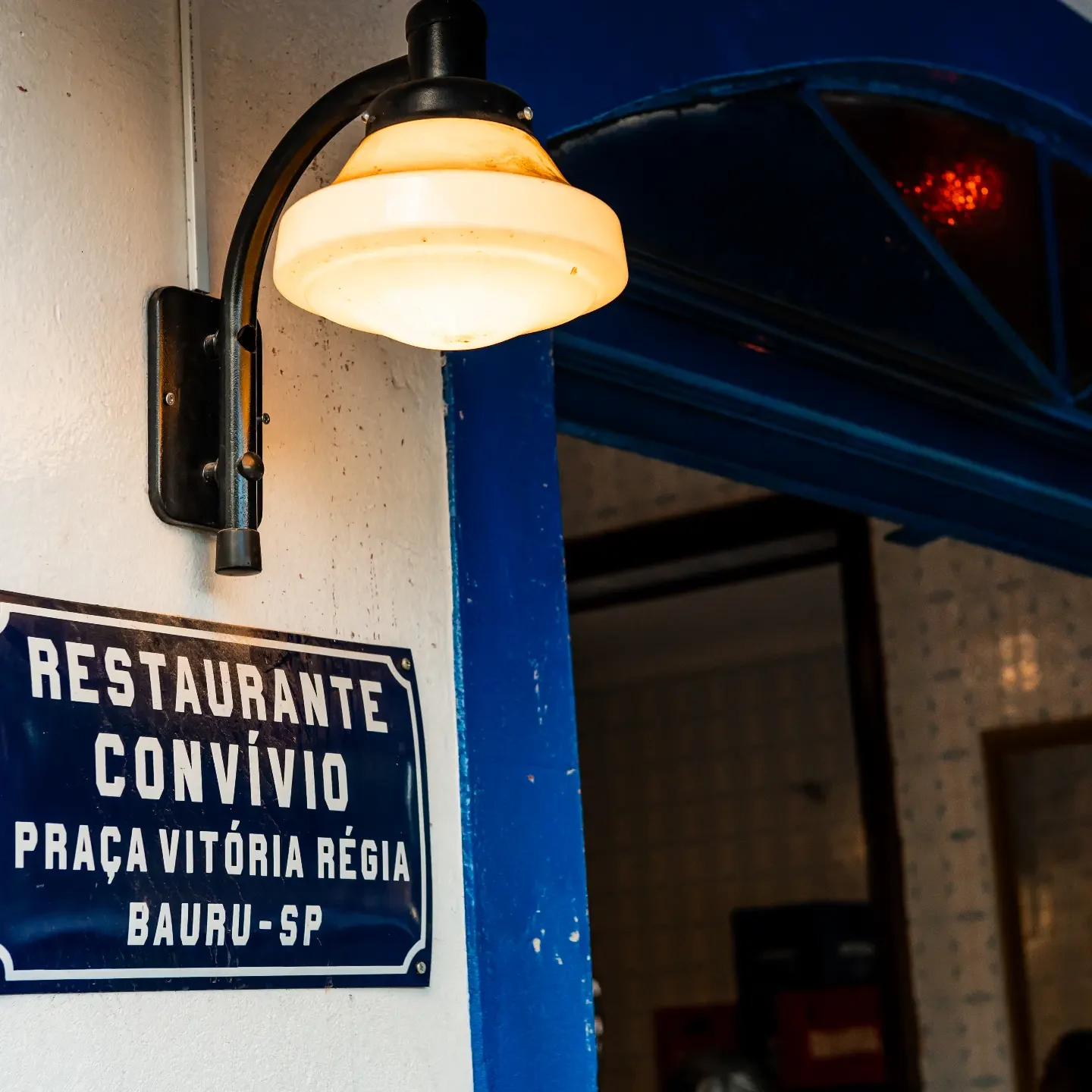 Entrada do Convívio: luminária antiga, batente azul e placa esmaltada Restaurante Convívio, Praça Vitória Régia, Bauru-SP
